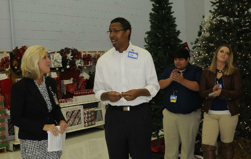 Carol Johnston (left), Wal-Mart senior vice president of operations, listens to Phil Keene, who was one of more than 25,000 Wal-Mart employees promoted Tuesday. 