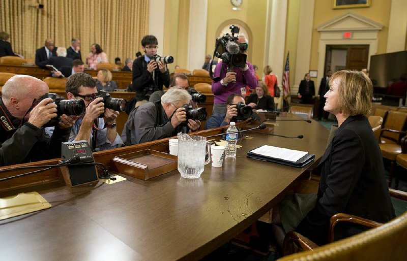 Photographers surround Marilyn Tavenner, the administrator of the Centers for Medicare and Medicaid Services, as she prepares to testify Tuesday on Capitol Hill in Washington before the House Ways and Means Committee hearing on the implementation of the Affordable Care Act. 