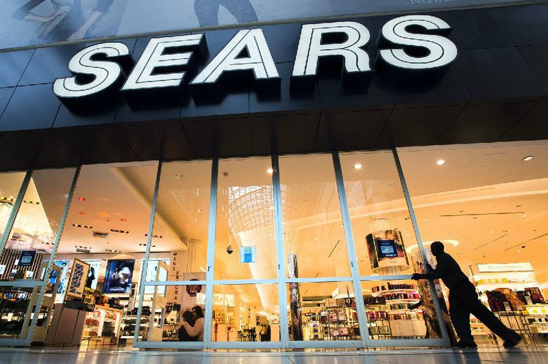 Sears at the Eaton Centre in Toronto opens its doors for business on Tuesday. Sears said Tuesday it is considering separating its Lands’ End and Sears Auto Center businesses from the rest of the company. 