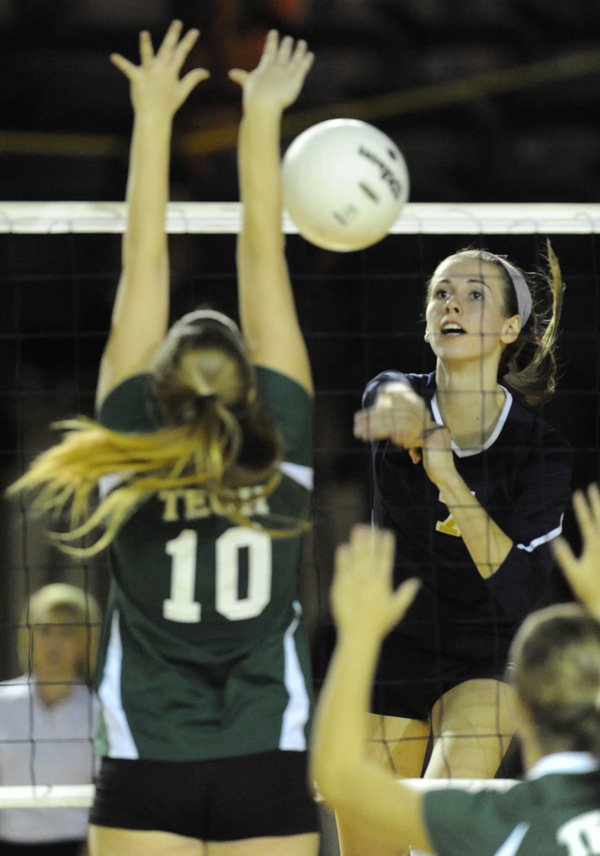 STAFF PHOTO ANDY SHUPE 
Reagan Robinson, Shiloh Christian sophomore, sends the ball over the net as Greene County Tech junior Courtney Cates defends Tuesday during the first round of the Class 5A state volleyball tournament in Charles B. Dyer Arena in Alma. Visit photos.nwaonline.com to see more photographs from the game.