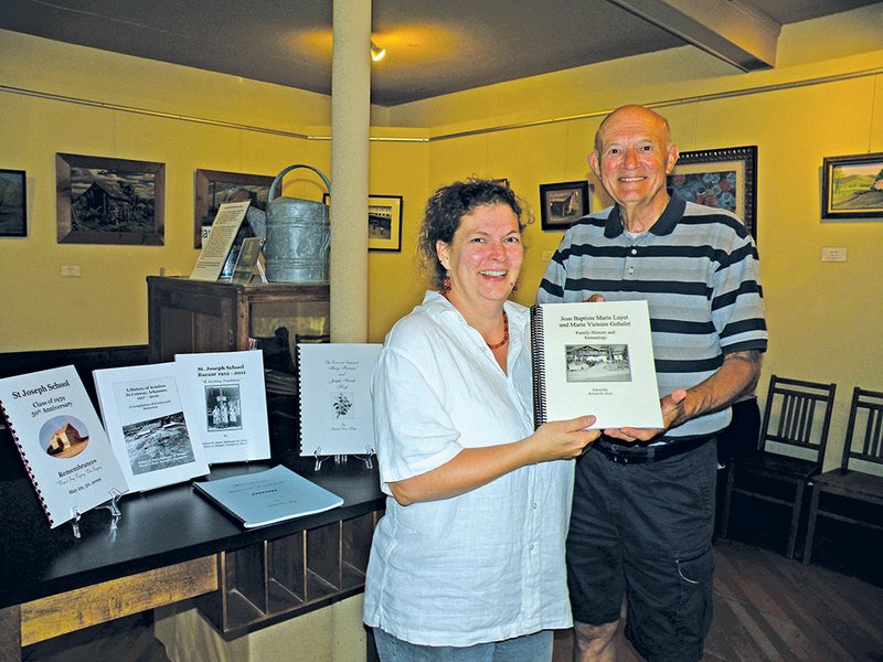 Robert Hoyt presents a copy of his latest book, Jean Baptiste Marie Luyet and Marie Victoire Gobelet Family History and Genealogy, to Lynita Langley-Ware, director of the Faulkner County Museum. Books can be purchased for $16 at the museum, which also has reference copies of several of Hoyt’s earlier works.