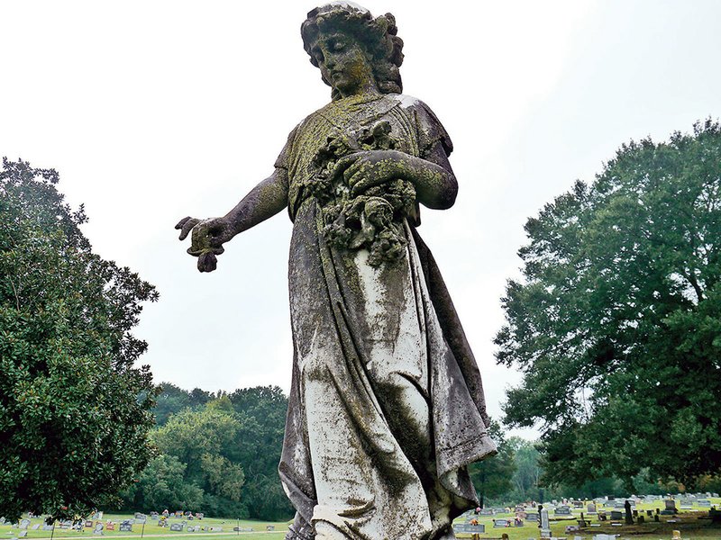 A statue of a young girl marks the grave of Laura Lee Henson in the Evergreen Cemetery in Judsonia.
