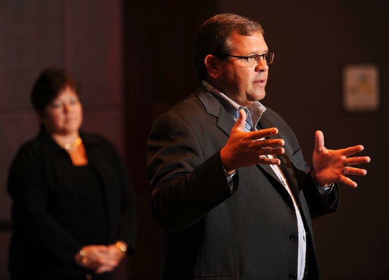 Duncan Mac Naughton, Wal-Mart executive vice president and chief merchandising and marketing officer, tells suppliers they must produce ingenious products, as Dina Howell, worldwide CEO for Saatchi & Saatchi X, listens Wednesday at the 13th annual Emerging Trends in Retailing Conference in Fayetteville. 