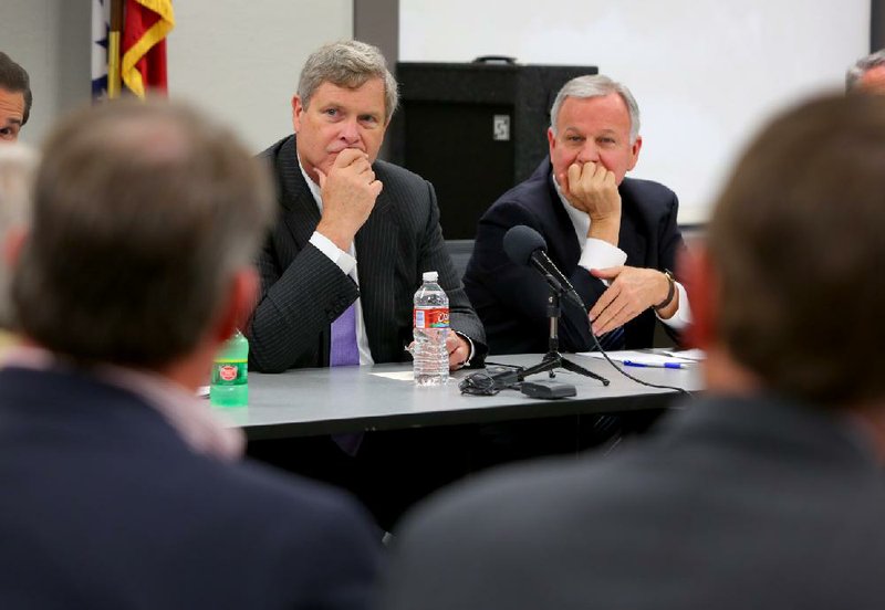 U.S. Agriculture Secretary Tom Vilsack (left) and Butch Calhoun, Arkansas secretary of agriculture, meet with farmers and farming-related industry representatives Wednesday in Little Rock. 