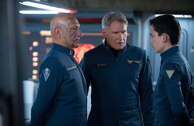 Harrison Ford (center) and Asa Butterfield got along just fine, but kept each other at arm’s length during the shooting of Ender’s Game to preserve the confrontational nature of their characters’ relationship. 