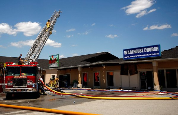 Bentonville firefighters work to eliminate remaining hot spots inside the Maria's Mexican Restaurant on S. Walton Blvd. on Sunday, June 29, 2013, in Bentonville. There were no injuries and the cause of the blaze is still under investigation.