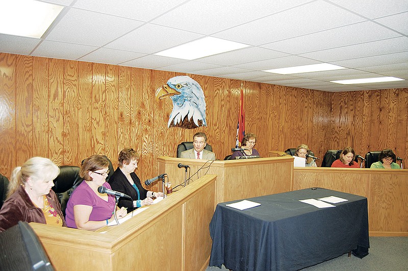 Seven women and Mayor Johnny McMahan fill the dais during meetings of the Bauxite City Council. From the left are council members Karen Brooks, Paula Matthews and Brenda Haney; McMahan; Treasurer Sheryl Johnson; City Attorney Pam Perry; and council members Allison Cain and Mona Struble. Several council members said the all-female makeup of the council has little effect on how the city is run. Others said it makes a difference in how council members approach city issues.