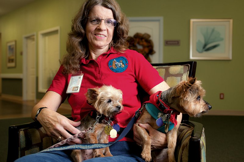 Kathy Shelton of Cabot is shown with her award-winning Yorkshire terrier therapy dogs, 
Bonnie, 13, left, and Randy, 15.