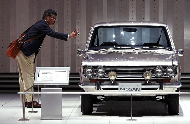 A visitor takes a photo Friday of the interior of a 1969 Nissan Bluebird 1600 at Nissan’s showroom in Yokohama, Japan. Nissan said it sold more than 91,000 cars last month, a record October for the company. 