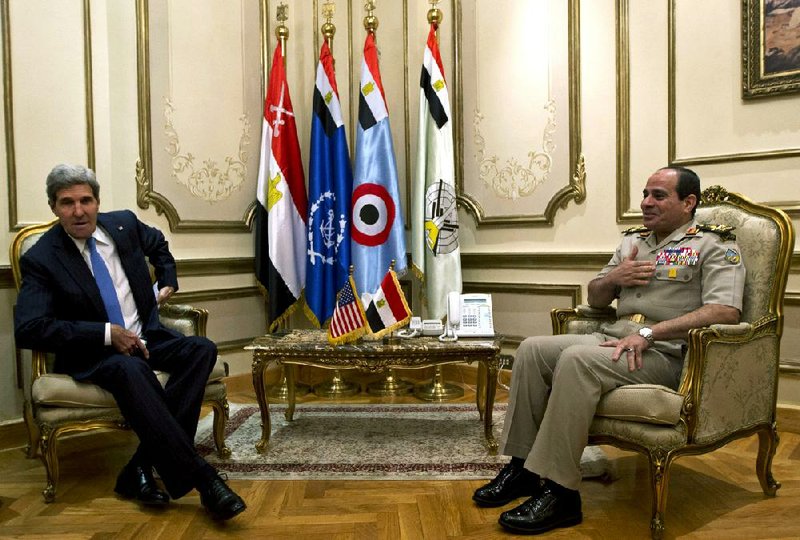 U.S. Secretary of State John Kerry, meets with Gen. Abdel Fattah el-Sissi, right, in Cairo, Egypt, Sunday, Nov. 3, 2013. Kerry is in Cairo pressing for reforms during the highest-level American visit to Egypt since the ouster of the country's first democratically elected president. The Egyptian military's removal of Mohammed Morsi in July led the U.S. to suspend hundreds of millions of dollars in aid. This is the first stop in an 11-day trip that will take Kerry to the Mideast and Europe. (AP Photo/Jason Reed, Pool)