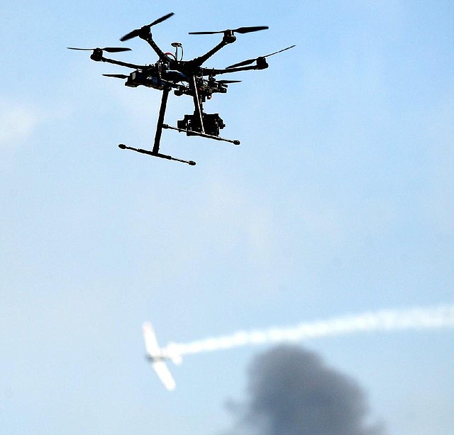 Eye's in the sky as a drone aircraft films the reenactment of "Tora Tora Tora" at the Wings Over Houston Airshow “Special Show” for the lifetime physically challenged in Houston, Texas on Oct. 25, 2013. (AP Photo/Conroe Courier, Kar B Hlava)