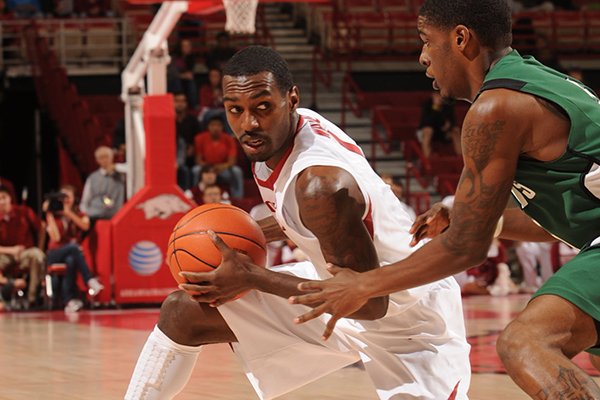 Arkansas senior guard Mardracus Wade, left, looks to pass around Northeastern State junior guard Keon Littleton during the first half of play Tuesday, Nov. 5, 2013, in Bud Walton Arena in Fayetteville