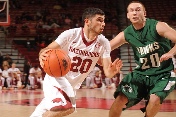 Arkansas senior guard Kikko Haydar, left, drives to the lane as Northeastern State junior guard Dalen Qualls defends during the first half of play Tuesday, Nov. 5, 2013, in Bud Walton Arena in Fayetteville. 