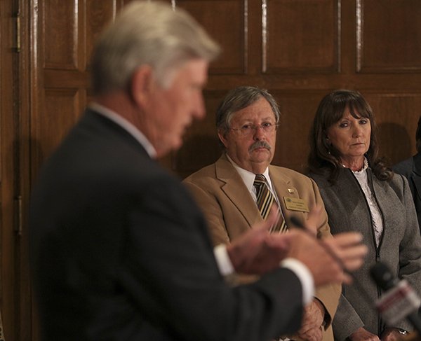 Gov. Mike Beebe (left) talks Monday at the state Capitol about a state police investigation into the Department of Community Correction as Sheila Sharp (right), the agency’s director, and Benny Magness, chairman of the Arkansas Board of Corrections, listen.