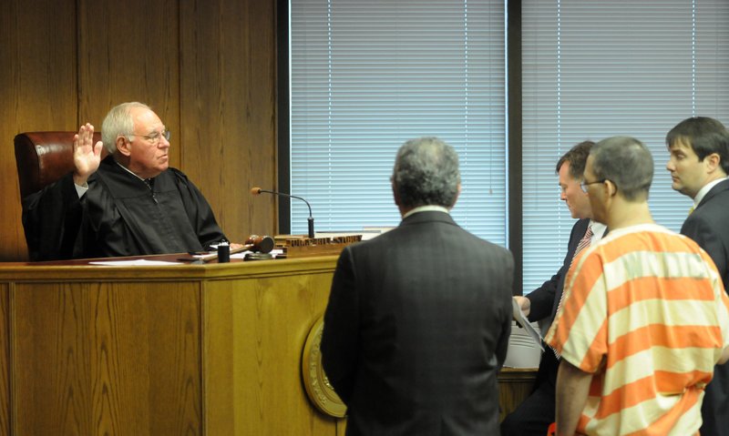 Judge William Storey, left, asks Anthony Swinford, right, to raise his right hand Tuesday, Nov. 5, 2013, in Judge Storey's courtroom at the Washington County Courthouse in Fayetteville during a plea negotiation. Swinford was one of four people charged with capital murder for the death of Ronnie Bradley.