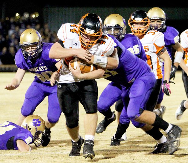 Photo by Sue Fancher 
Cody Robinson powers ahead with the ball during play against the Berryville Bobcats on Friday. The Lions defeated the Bobcats in Berryville, 30-12.