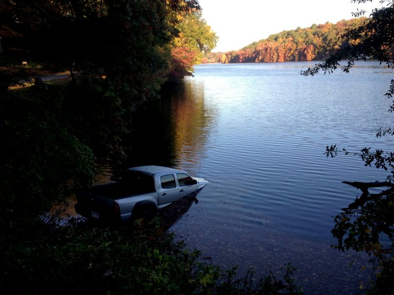 A pickup rests in North Little Rock's Lake No. 1 on Thursday, Nov. 7, 2013, after the driver got out to take a photograph.