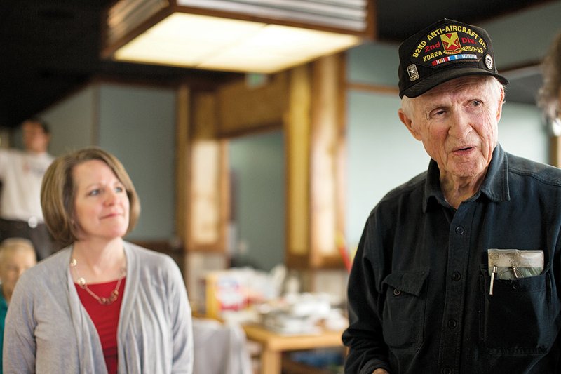 Melvin Bailey talks about his time in World War II and the importance of the dog tag he still carries. Susan Jarvis of the Tracy Tidwell Team, ERA Henley Real Estate, listens in the background.