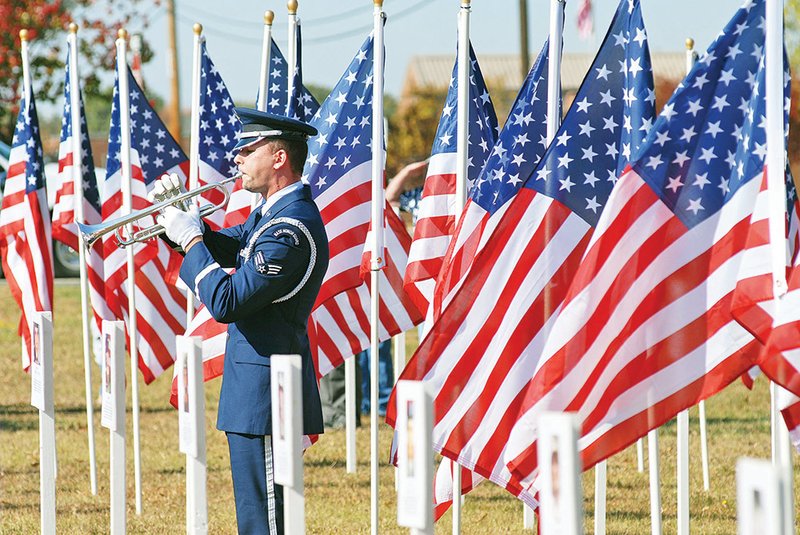 Senior Airman Austin Dischert plays taps during a Veterans Day ceremony at the Jacksonville Museum of Military History in 2010. This year’s celebration will feature a concert by the Jacksonville High School Choir.