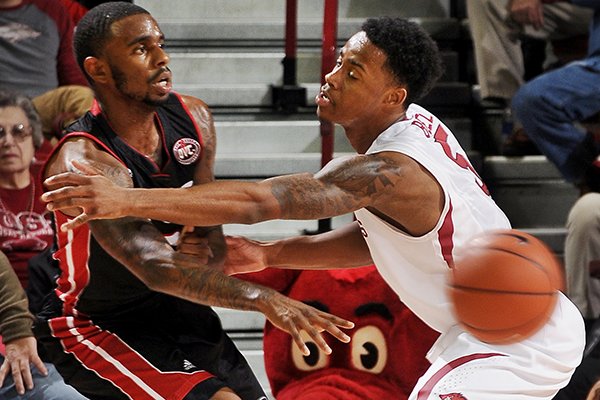 Arkansas's Anthlon, right, guards SIU-Edwardsville's Maurice Wiltz during the second half of the basketball game on Friday November 8, 2013 in the Bud Walton Arena in Fayetteville. 