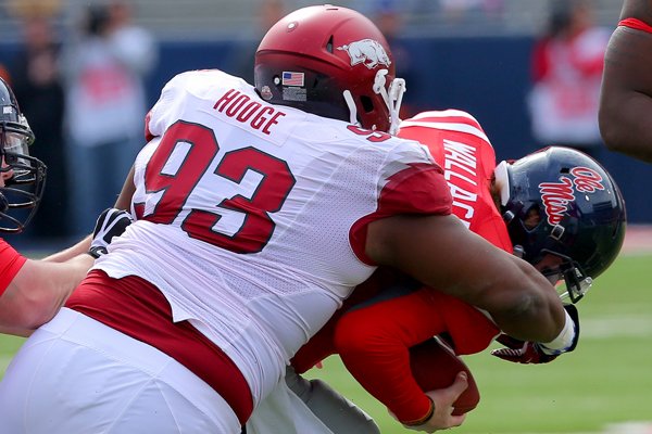 Arkansas defensive tackle DeMarcus Hodge (93) sacks Ole Miss quarterback Bo Wallace on a third down in the first quarter Saturday at Vaught-Hemingway Stadium in Oxford, Miss.