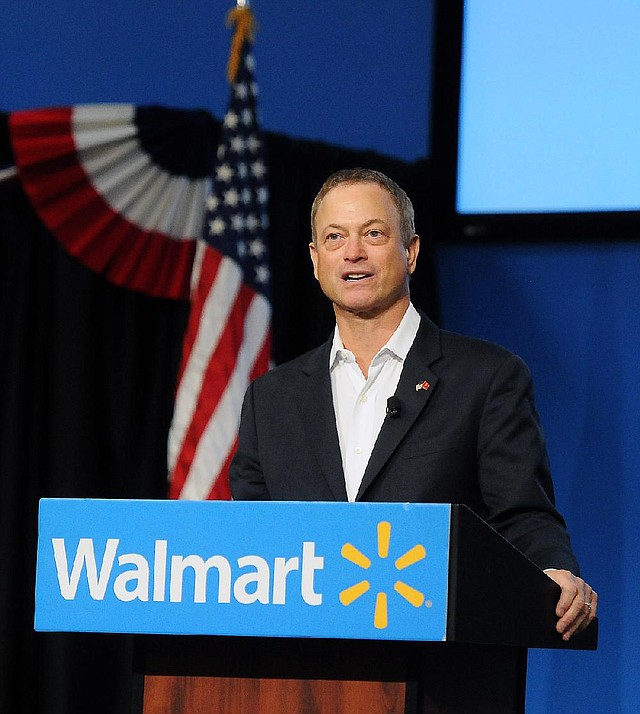 Actor Gary Sinise speaks at Wal-Mart Inc.’s Bentonville headquarters Monday during Veterans Day celebrations. Sinise’s nonprofit, the Gary Sinise Foundation, and musical group, the Lt. Dan Band, have raised millions for veterans. 