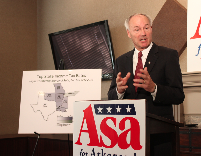 Republican gubernatorial candidate Asa Hutchinson calls for lowering the state's individual income tax for middle-class earners Tuesday at his Little Rock campaign headquarters.