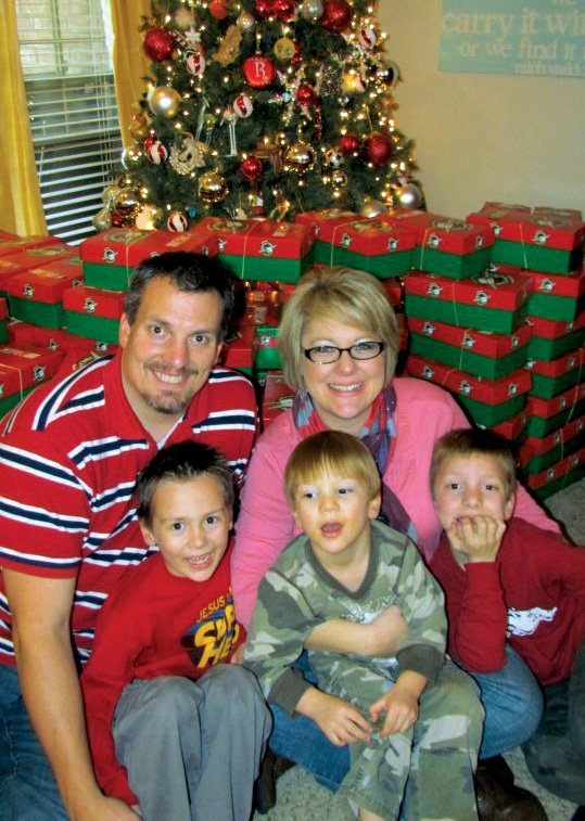 Shane and Anna Wanamaker and their three sons, from the left, Luke, Jack and Reed, start packing Operation Christmas Child boxes in early November and make it an extended family celebration. Last year, the family packed 500 shoe boxes. The drop-off location for the boxes, which opens Monday, is at Fellowship Bible Church, 1051 Hogan Lane in Conway. Already-wrapped boxes are available at the church.
