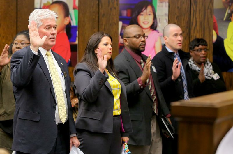 North Little Rock School District Superintendent Kelly Rodgers (from left), Assistant Superintendent Beth Stewart, Micheal Stone and other district officials are sworn in Wednesday before speaking against the Capitol Lighthouse Charter School. 