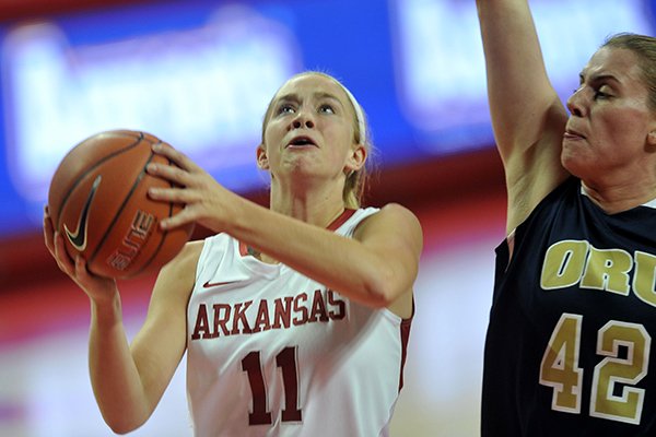 Arkansas' Calli Berna drives to the hoop past Oral Roberts defender Sarah Shelton in the first half of Wednesday evening's game at Bud Walton Arena in Fayetteville.