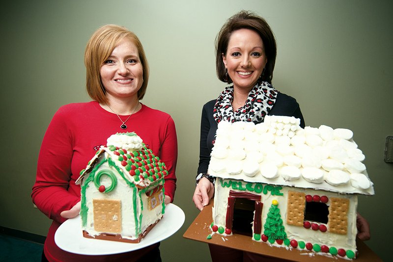 Sheryl Sample, left, and Jennifer Hill, co-chairwomen of this year’s Dazzle Daze, hold decorated reusable gingerbread houses. The Conway Regional Women’s Council, which sponsors the annual fundraiser, will sell the gingerbread-house kits at the event, which will be held Thursday, Friday and Saturday at the Conway Expo Center, 2505 E. Oak St.