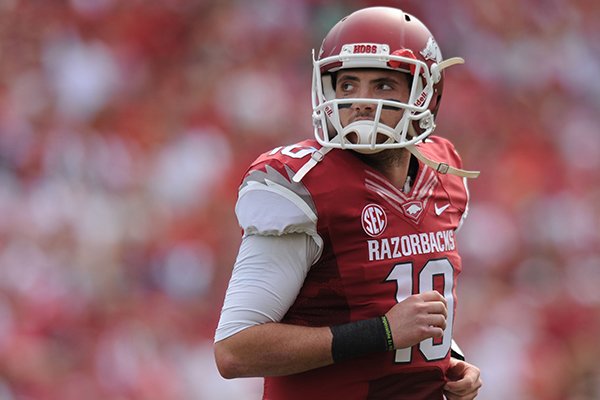 Arkansas quarterback Brandon Allen walks off the field after the Razorbacks failed to convert on third down during the second quarter of play Saturday, Oct. 12, 2013, at Razorback Stadium in Fayetteville.