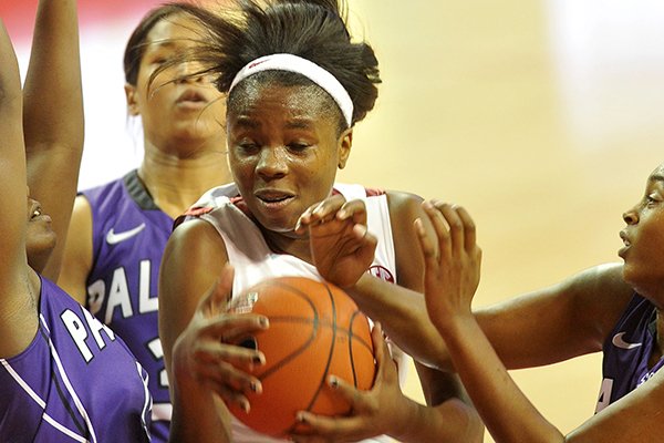 Arkansas' Jessica Jackson is fouled as she tries to drive to the hoop past three Furman defenders in the first half of Saturday afternoon's game at Bud Walton Arena in Fayetteville.