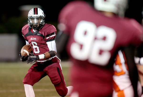 Springdale senior Deandre Murray carries the ball on a punt return against Rogers Heritage during the first half on Friday, Oct. 25, 2013, at Bulldog Stadium in Springdale.