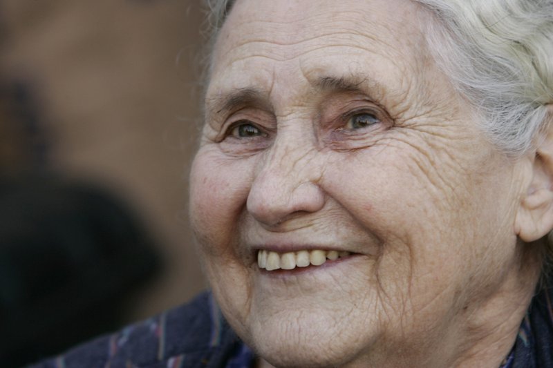 In this Thursday, Oct. 11, 2007 file photo, British writer Doris Lessing, winner of the 2007 Nobel Prize in literature, smiles as she talks to members of the media, shortly after the announcement of the award, outside her home in north London. Doris Lessing, the free-thinking, world-traveling, often-polarizing writer of "The Golden Notebook" and dozens of other novels that reflected her own improbable journey across the former British empire, has died, early Sunday, Nov. 17, 2013. She was 94.  (AP Photo/Lefteris Pitarakis, File)