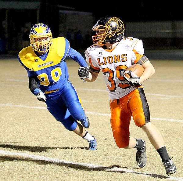     Photo by Sue Fancher 
Gravette senior, Shay Shimer, carries the ball and is pursued by a Valley View defender during playoffs at Jonesboro on Friday.