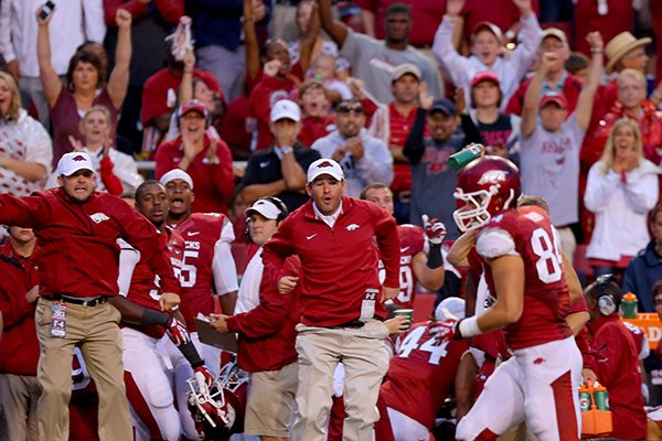 Coaches and fans celebrate as Hunter Henry hauls in a pass for a big gain late in the first quarter of a Saturday, Sept. 28, 2013 game against Texas A&M at Donald W. Reynolds Razorback Stadium in Fayettville. 