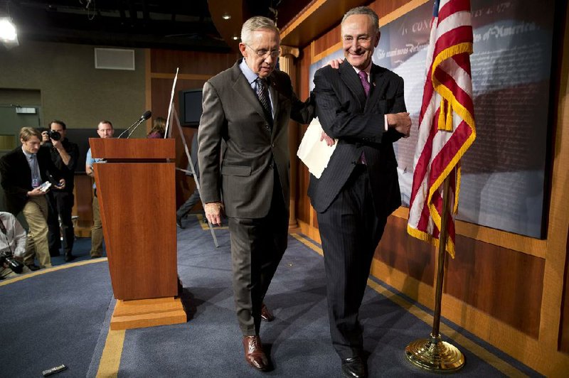 Senate Majority Leader Harry Reid (left) and Sen. Charles Schumer, D-N.Y., leave a news conference Thursday after the Democratic majority pushed through a change to filibuster rules in the Senate. Reid said the change was not a reason for celebration. 