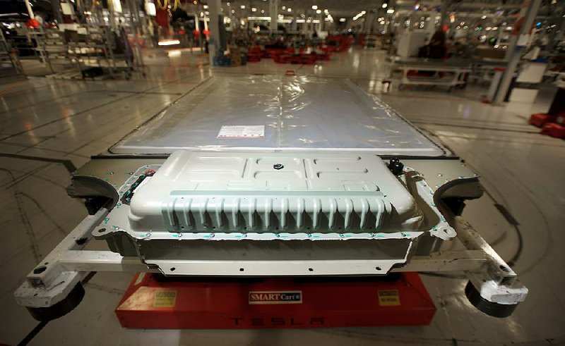 Federal safety inspectors are examining whether design of the Tesla Model S and its advanced lithium-ion battery pack — seen here at the Tesla Motor Co. assembly plant in Fremont, Calif. — are behind two recent battery fires.