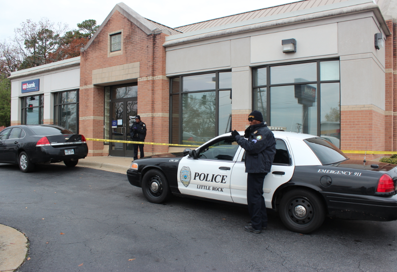 Little Rock police work the scene Tuesday, Nov. 26, 2013, after the U.S. Bank branch at 6320 W. Markham St. was robbed.