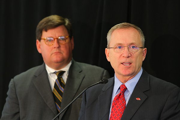 War Memorial Stadium Commission Chairman Kevin Crass, left, listens as University of Arkansas Athletic Director Jeff Long, right, answers questions about the amended contract between Arkansas and War Memorial Stadium in a Tuesday afternoon press conference.