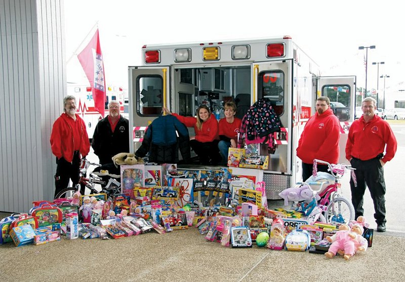 NorthStar EMS employees in Heber Springs hold fundraisers each year to raise money to shop for toys for Jayson Jones Fill A Ford, which gives the toys to the Arkansas Dream Center’s Christmas Mall in Heber Springs. Pictured with toys purchased in a previous year are, from the left, Paul Henley; David Banks; Amanda Badders; Traci Tutor, also a coordinator of the dream center; Richie Balmer; and James Tinnin.