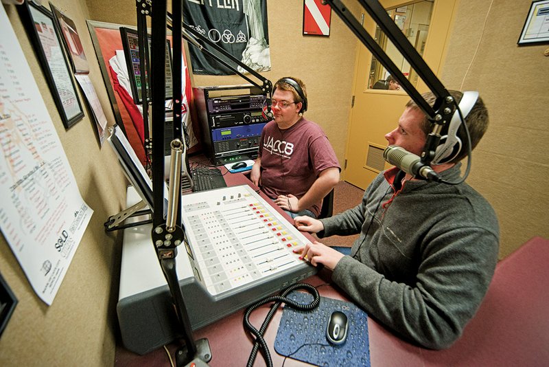 Cave City High School seniors Nick Gay, left, and Nate Ayers go on the air in the studio of KVMN 89.9 FM, one of only two high school radio stations in the state.