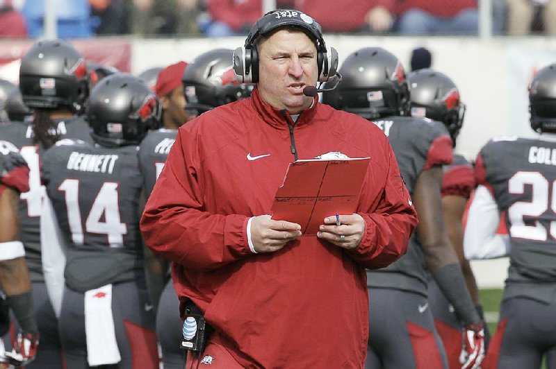 Arkansas coach Bret Bielema walks onto the field in the first half of an NCAA college football game against Mississippi State in Little Rock, Ark., Saturday, Nov. 23, 2013. (AP Photo/Danny Johnston)