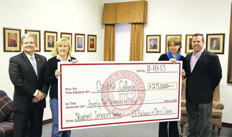 From the left, Richard Dawe, Ozarka College president; Chris Dawe; and Connie Moser and Mike Watson, Ozarka College Foundation Board members and capital campaign co-chairs, stand with a check that represents a recent contribution by the Dawes to the college. 