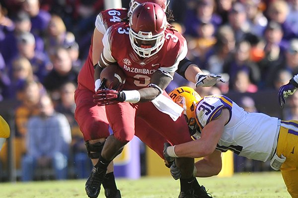 Arkansas running back Alex Collins runs the ball during the first quarter of Friday afternoon's game at Tiger Stadium in Baton Rouge, La. 