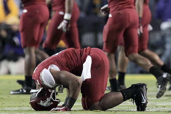 Arkansas receiver Julian Horton falls to the ground after a heartbreaking 31-27 loss to LSU. 