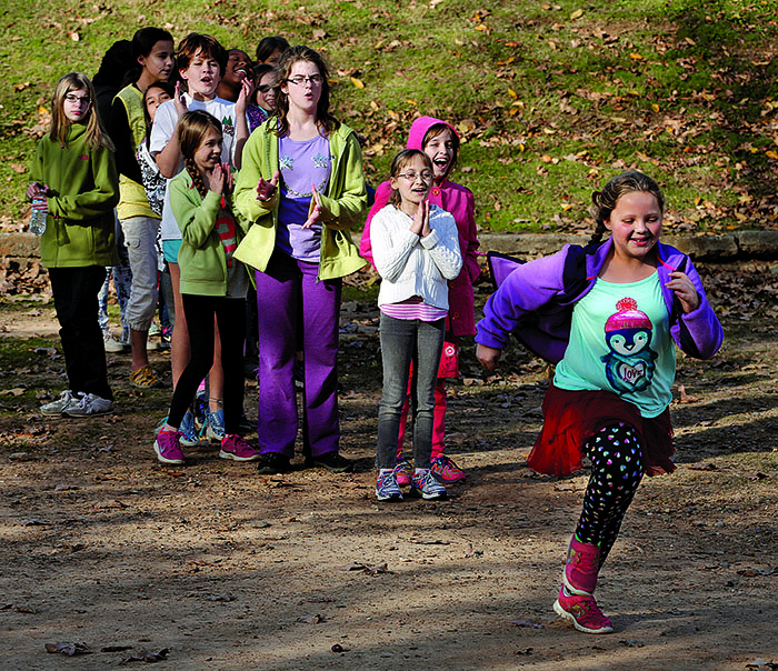 Arkansas Democrat-Gazette/JOHN SYKES JR. - A group of mothers created a chapter of the national Girls on the Run that take girls through self-esteem and empathy exercises in the form of running games. On the right, Bella Kerby, 9, a fourth-grader, runs as part of a group exercise.