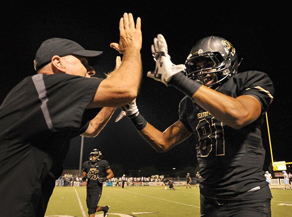   FILE PHOTO BEN GOFF 
Barry Lunney, Bentonville coach, high-fives wide receiver Jimmie Jackson after he scored a touchdown Sept. 27 against Springdale Har-ber at Tiger Stadium in Bentonville.
