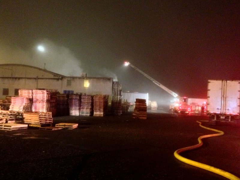 Fire crews battle a blaze at the Best Pallet, Inc. warehouse, 1500 E. 15th Street, on Tuesday night.